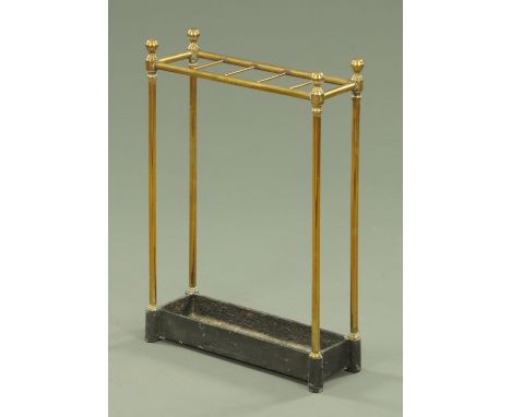 A 19th century brass stick stand, five apertures with weighted iron drip tray.  Height 60 cm, width 41 cm.