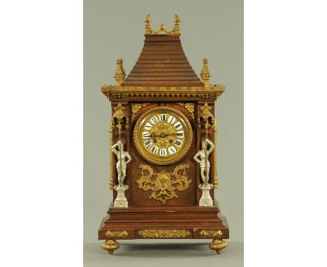 A Black Forest mantle clock, the gilt brass dial with enamel Roman numerals inscribed for Ferguson and McBean, flanked to eit