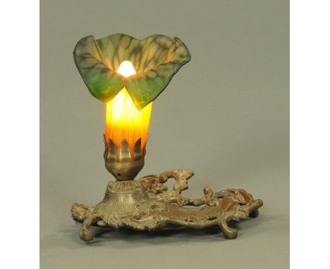 An Art Nouveau style table lamp, with leaf shaped shade and with metal base.  Height 20 cm.