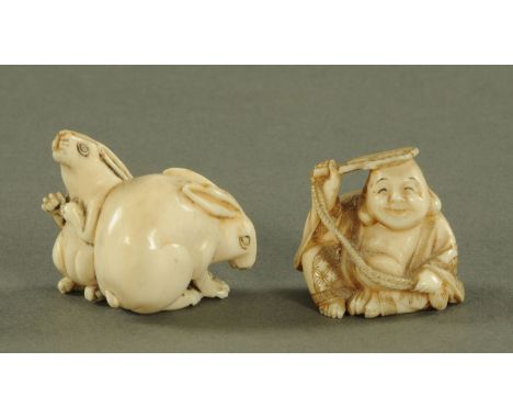 A Japanese carved ivory netsuke, Taisho period, carved as two rabbits, one hunched the other on its haunches, signed, 4.1 cm 