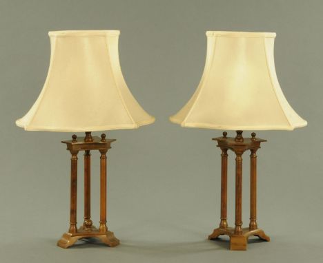 A pair of patinated brass table lamps, 20th century, with triform top and base united by plain columns.  Height excluding lig