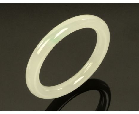 A Chinese white jade bangle.   Internal diameter 55 mm. CONDITION REPORT: Weight 30.2 grams.  It appears to be in good order 