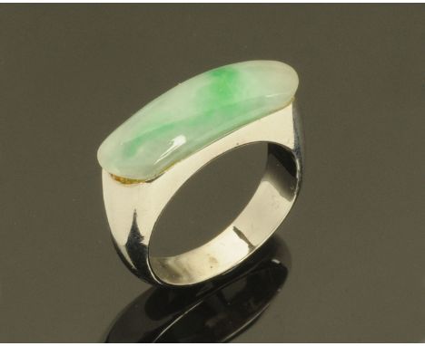 A Chinese 18 ct white gold ring, jade set, size L, stamped "18 K", 4.8 grams.  CONDITION REPORT: The jade stone measures 21 m