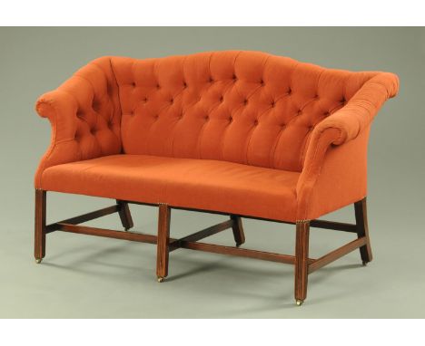 A George III mahogany settee, upholstered in deep buttoned corded material and raised on moulded front legs united by stretch