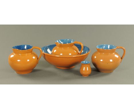 A Brannan Barum toilet set, three jugs, basin and toothbrush container, each piece incised.  