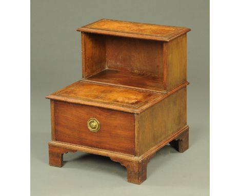 An early 19th century mahogany step commode, with gilt tooled leather steps above a pullout drawer with ring handle, all upon