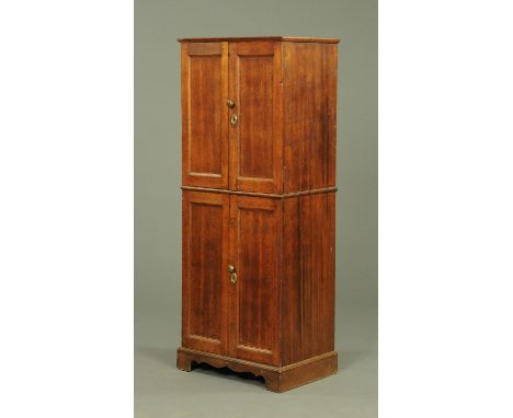 A 19th century oak double cupboard, the upper section fitted with pigeonholes and shelves, the lower section with single shel
