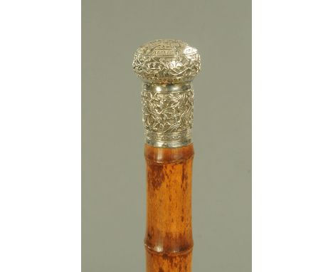 A Chinese silver mounted bamboo walking stick, late 19th century, the grip with initials "QG" framed by bats and decorated wi