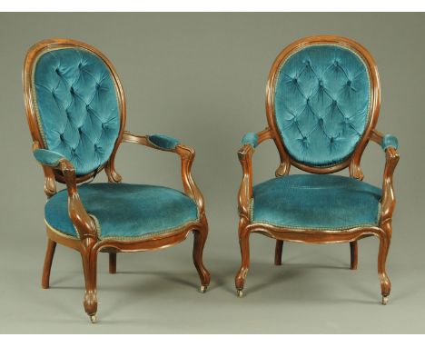 A pair of Victorian stained beech armchairs, upholstered in blue material with button back and stuffover arm rests and seats,