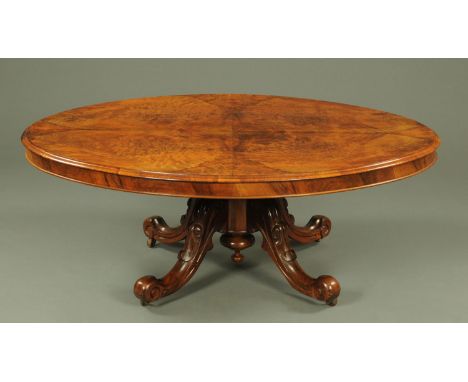 A Victorian walnut Loo table, with well figured top supported on three foliate capped downswept legs terminating in ceramic c