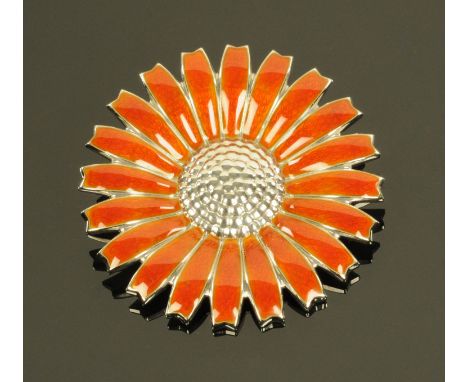 A Georg Jensen silver and enamel sunflower brooch, in original presentation box (see illustration).
