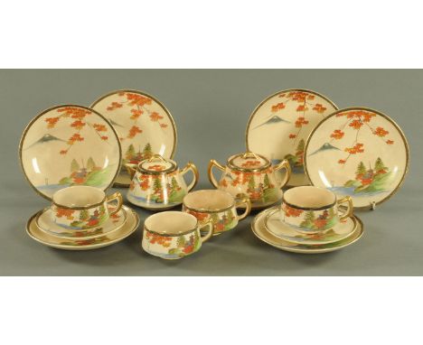 A Japanese Satsuma part tea service, each piece decorated with a building flanked by trees beneath a maple tree and with Moun