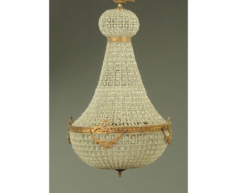 A brass and glass bag type chandelier.  Height 94 cm, diameter 50 cm. 