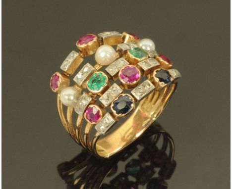 A diamond and multi-gemstone set ring, the stones set on five gold metal strands and comprising diamonds, emeralds, pearls, r