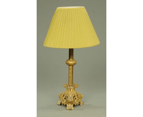 A cast and gilded metal table lamp, the circular stem with embossed foliate scrolling knop and ivy leaf decoration upon a fan