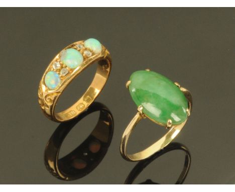 A Victorian 18 ct gold three stone opal and diamond set ring, Birmingham 1896, ring size L and a jade set ring in gold colour