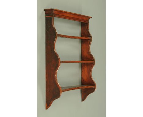 A set of Regency mahogany shelves, wall mounting, with convex fronts.  Width 77 cm, height 96 cm.  CONDITION REPORT: The shel