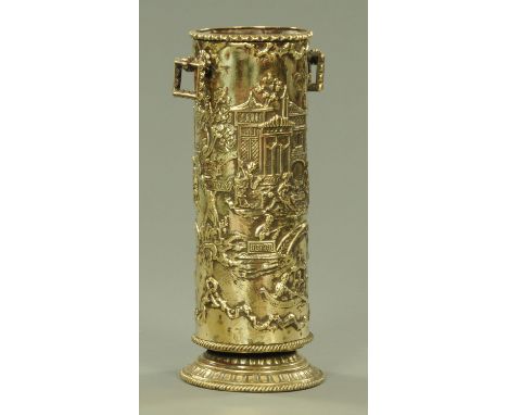 A Chinese inspired embossed brass stick stand, late 19th century, embossed with numerous figures, pagodas and foliage with re