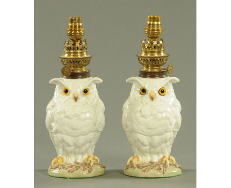 A pair of French porcelain owl novelty oil lamps, circa 1890, each with glass inset eyes, brass light mount and printed mark 