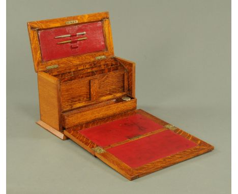 A good Victorian light oak table top stationery cabinet / writing slope, late 19th century, the top with metal shield shape m