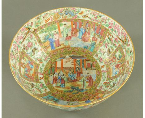 A large Canton enamel punch bowl, circa 1850, decorated throughout with panels of court figures between butterfly and blossom