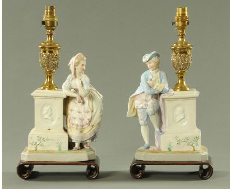 A pair of Continental porcelain table lamps, early 20th century, modelled as a gentleman and his lady companion each standing