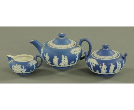 A Wedgwood blue jasper ware bachelors three piece tea set, early 20th century, with applied classical sprig decoration, impre