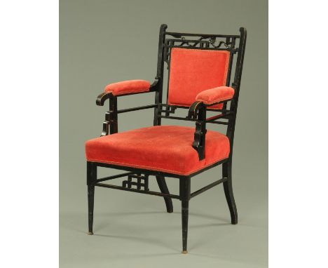 A Japanese inspired aesthetic armchair, having an ebonised and part upholstered frame with horsehair and sprung stuffover sea