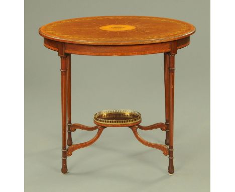 An Edwardian inlaid mahogany and satinwood banded oval occasional table, with turned legs united by shaped stretchers and ova