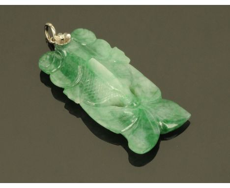 A large Chinese green jade fish pendant, the white coloured metal mount set with a small diamond.  52 mm x 18 mm.  CONDITION 