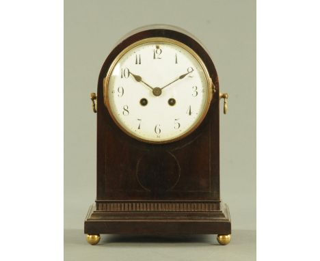 A late 19th century arched top mantle clock, having an enamel dial with eight day movement chiming on a single gong, with Geo