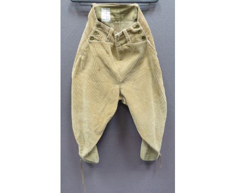 Pair of Women's Land Army Breechestan, corduroy, wide leg breeches.  Waist with side fastened front panel with two slash, ope