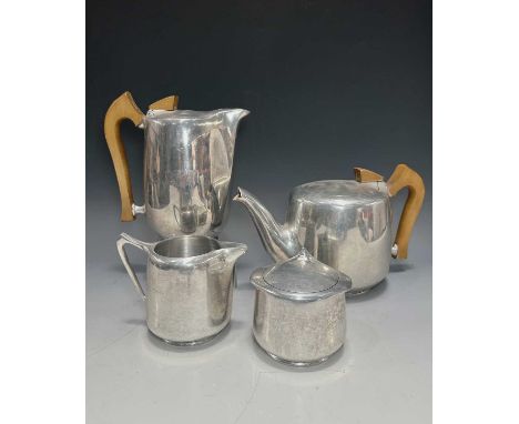 A four piece Picquot Ware tea set, including teapot, jug, lidded sugar pot and coffee pot, spun aluminium with wooden handles
