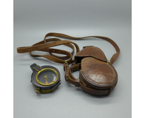 A WWI military issue compass and case 