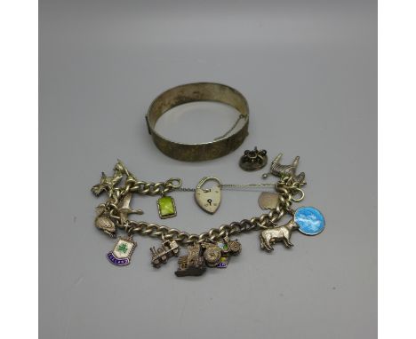 A silver bangle and a charm bracelet, 93g 