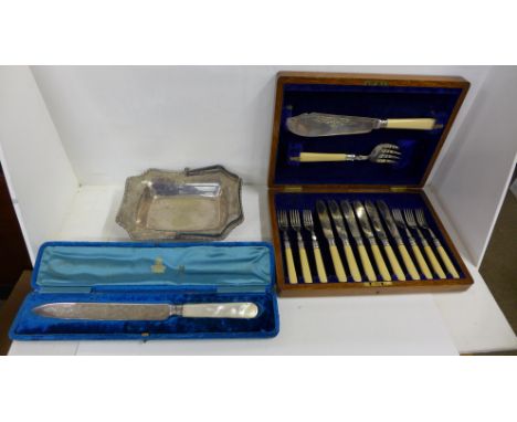 A set of fish knives and forks with servers, cased, a plated basket and an Elkington bread knife with mother of pearl handle 