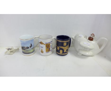 A Matlock Bath crested model WWI aircraft, two USAF mugs, a novelty aircraft teapot and a mug with a spitfire 