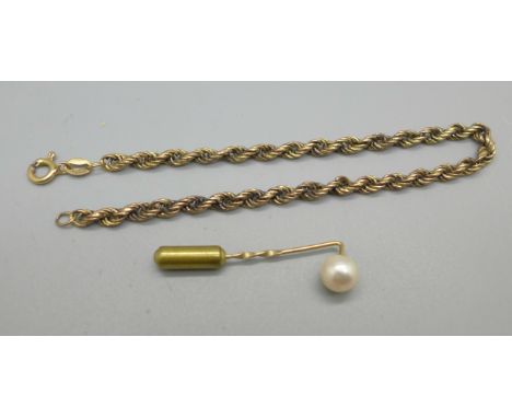 A 9ct gold stick pin set with a pearl, 0.8g, and a 9ct gold rope chain bracelet, 2.7g, clasp a/f 