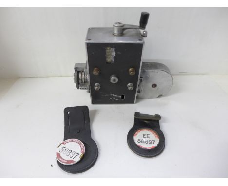 A Setright ticket machine and two bus driver badges 
