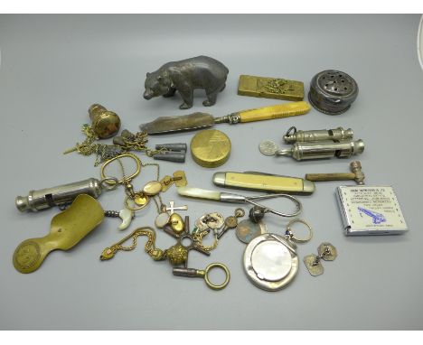 A silver compact and rattle, both a/f, a model of a bear, an ARP whistle, a manicure case, watch keys, etc. 