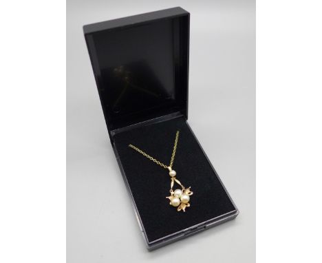 A 9ct gold and pearl pendant on a silver gilt chain 