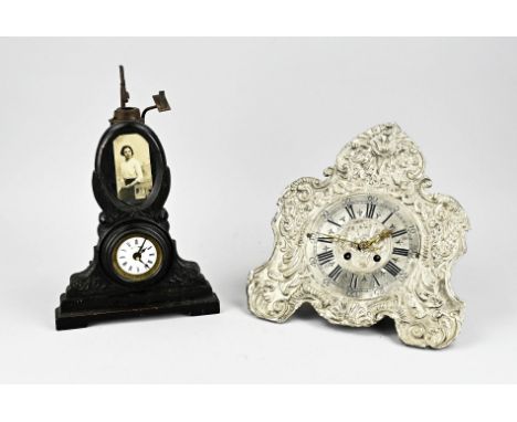 Two antique clocks. 1x Separate travel alarm clock with burner? (worm birth). 1x German wall clock (wedding), defective. Size
