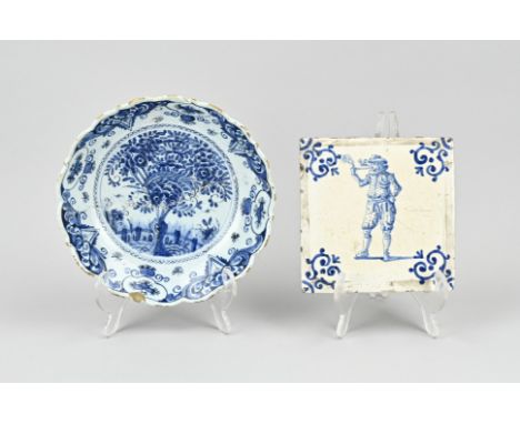 18th century Delft fayence dish with chinoiserie decor, contoured, restoration. Plus a 17th century tile with an image of a p