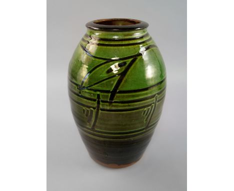 Michael Cardew OBE, British, 1901-1983, a tall green slipware Wenford Bridge earthenware vase, decorated with horizontal band