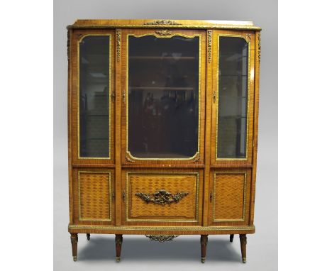 A French Louis XVI style display cabinet, 20th century, overall applied with gilt metal mouldings,  with moulded top, above g