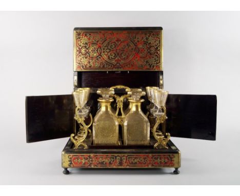 A French premiere partie boulle work and ebonised drinks cabinet, 19th century, the top and front applied with brass and red 