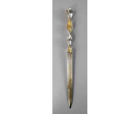 A Stuart Devlin silver and silver gilt letter opener, London 1968, the knife with twisted plain silver and textured silver gi