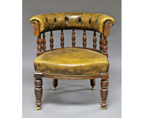 A Victorian button back leather captains chair, 19th century, leather back top rail with carved baluster supports, raised on 