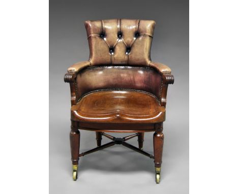 A large Victorian mahogany and leather button back captains chair, the swival top with shaped seat, raised on baluster legs w