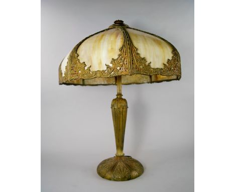 An American gilt metal and glass Art Deco lamp, early 20th century, in the Tiffany taste, the domed sectional shade with foli